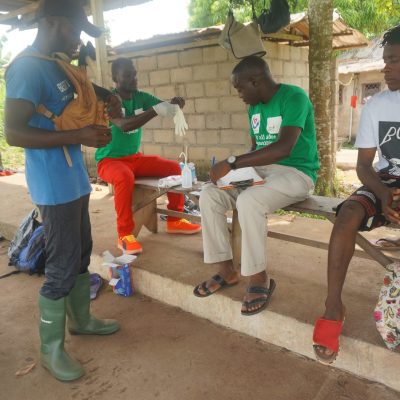 Dr. Aloby & Volunteer doing testing in the community