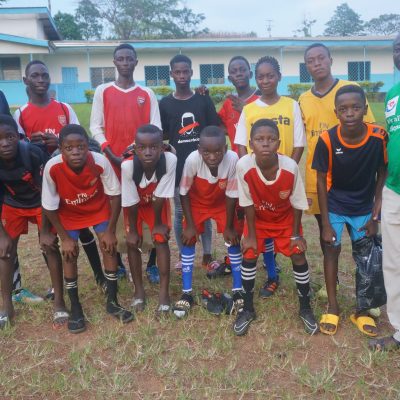 Dr. Aloby with kids from a youth sports academy